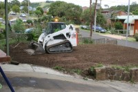 The bobcat levelling the front yard